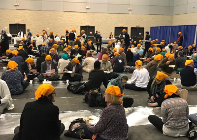 Toronto the Parliament of World Religions a scene of people of all different backgrounds eating Langar  provided by the Sikhs of Toronto.